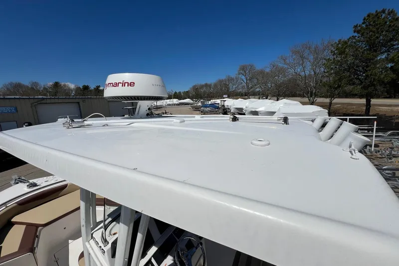 Slide: The Image of 2018 ROBALLO R242 boat with radar equipment, parked outdoors under clear blue sky. - 11