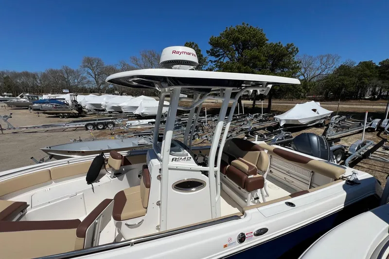 Slide: The Image of 2018 ROBALLO R242 boat with Raymarine equipment, parked outdoors under clear blue sky. - 17