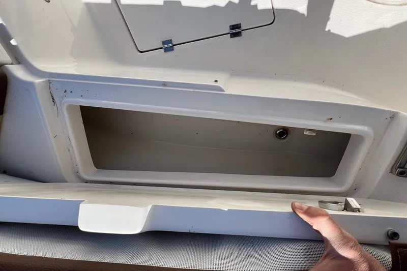 Slide: The Image of Open storage compartment on a 2018 ROBALLO R242 boat, showing interior details. - 20