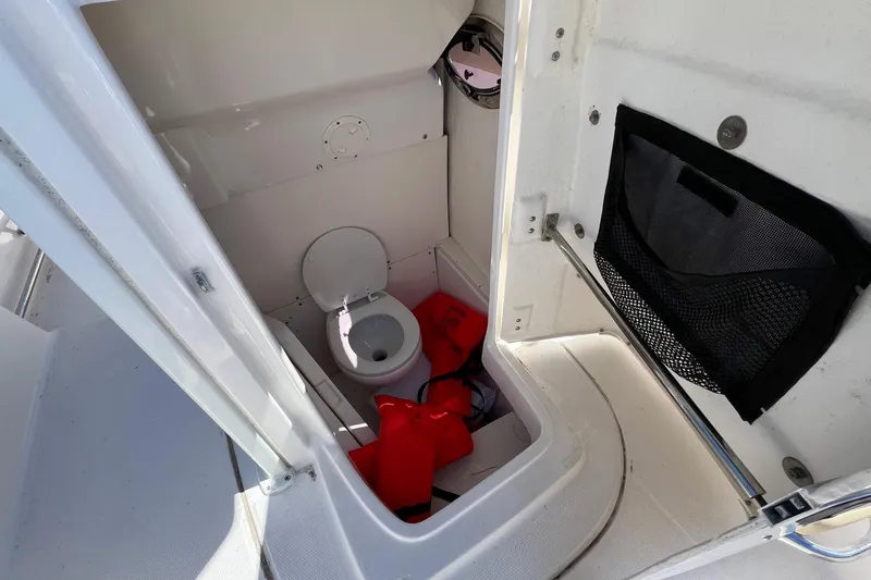 Slide: The Image of 2018 ROBALLO R242 boat interior with toilet and life jackets. - 21