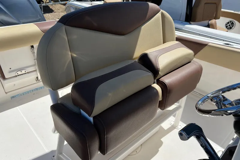Slide: The Image of 2018 ROBALLO R242 boat seat with brown and beige upholstery, near steering wheel. - 24