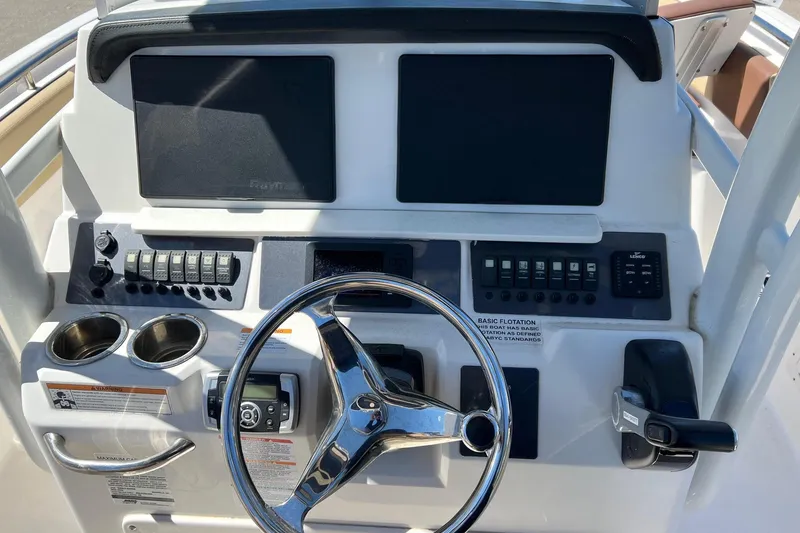 Slide: The Image of 2018 ROBALLO R242 boat dashboard with steering wheel and control panels. - 25