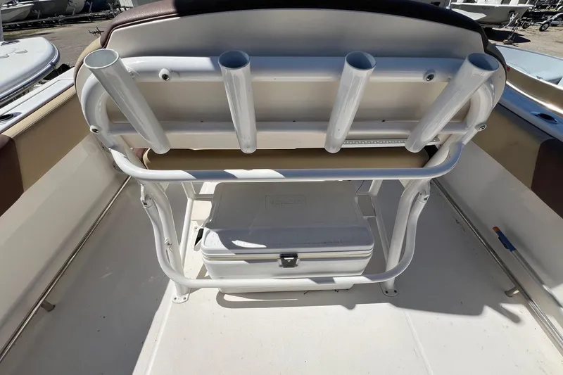 Slide: The Image of 2018 ROBALLO R242 boat interior with rod holders and cooler storage. - 26