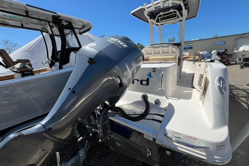 Slide: The Image of 2018 ROBALLO R242 boat with Yamaha outboard motor, parked outdoors under clear blue sky. - 3