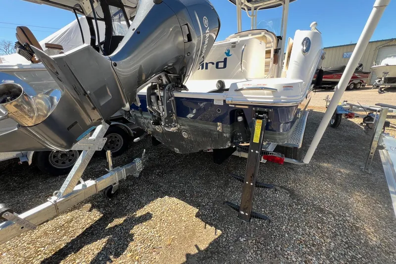 Slide: The Image of 2018 ROBALLO R242 boat with outboard motor on trailer in sunny outdoor setting. - 31