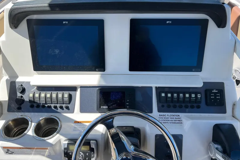 Slide: The Image of 2018 ROBALLO R242 boat dashboard with dual screens and control panel. - 5