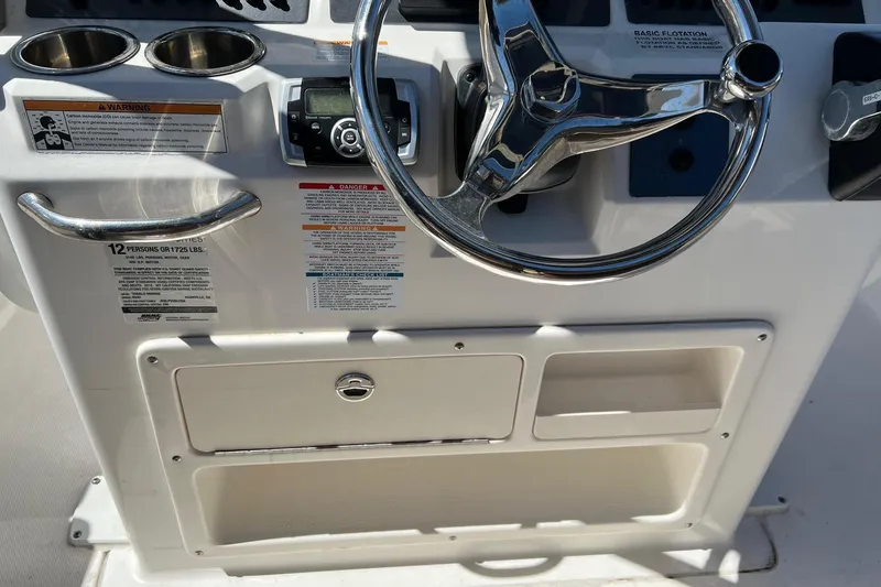 Slide: The Image of 2018 ROBALLO R242 boat dashboard with steering wheel and control panel. - 6