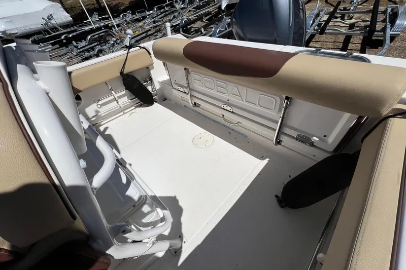 Slide: The Image of 2018 ROBALLO R242 boat interior with beige seating and storage compartments. - 8
