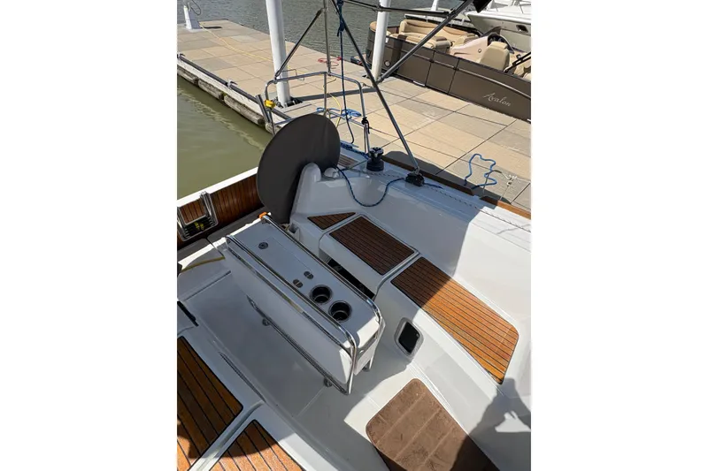 Slide: The Image of 2017 Jeanneau Sun Odyssey 349 sailboat cockpit with wooden accents, docked at marina. - 13