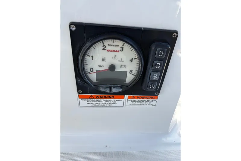 Slide: The Image of Yanmar RPM gauge on 2017 Jeanneau Sun Odyssey 349 sailboat dashboard with warning labels. - 18