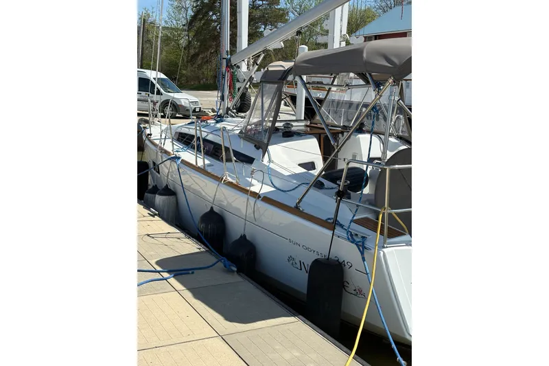 Slide: The Image of 2017 Jeanneau Sun Odyssey 349 sailboat docked, featuring sleek design and modern amenities. - 2