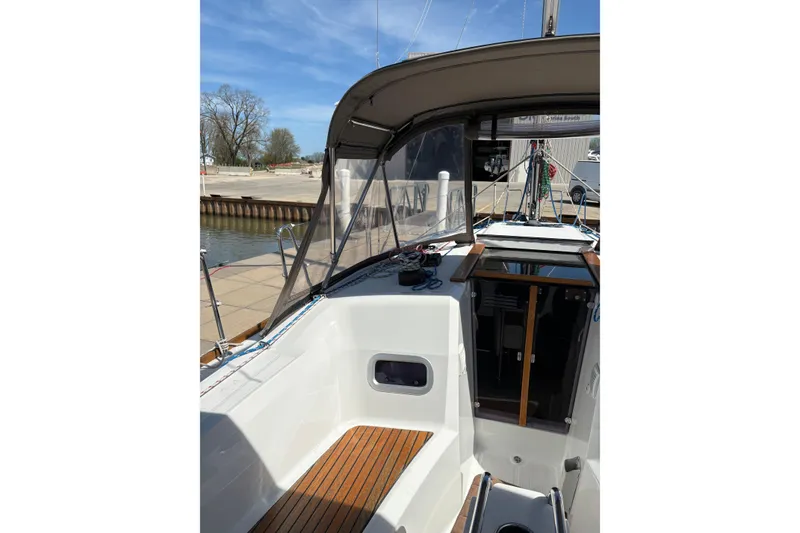 Slide: The Image of 2017 Jeanneau Sun Odyssey 349 sailboat cockpit with wooden flooring and canopy. - 21
