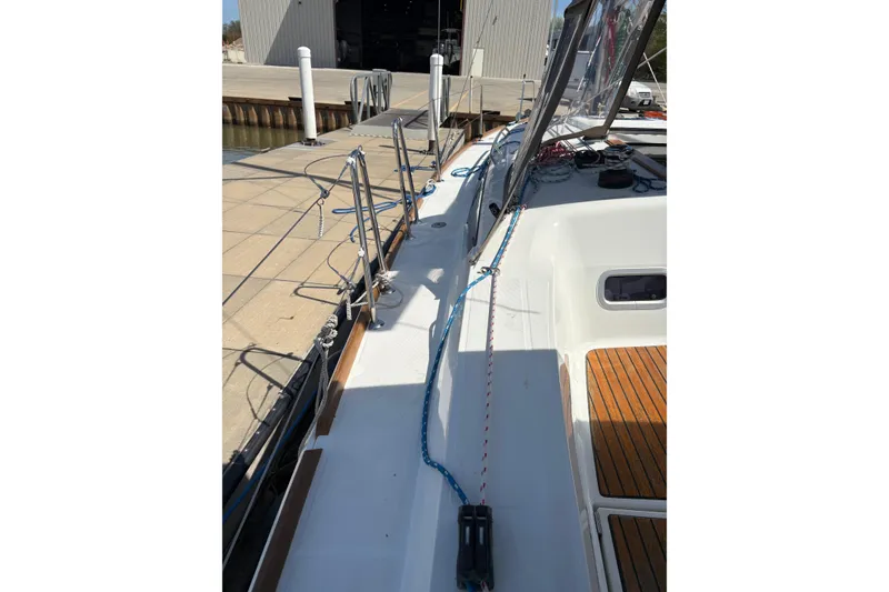 Slide: The Image of 2017 Jeanneau Sun Odyssey 349 sailboat deck with ropes and dockside view. - 23