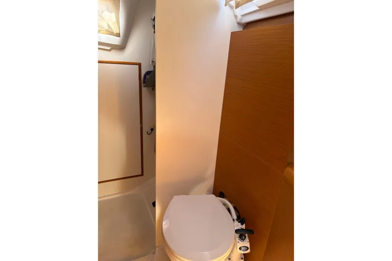 Slide: The Image of Bathroom interior of 2017 Jeanneau Sun Odyssey 349 sailboat, featuring a compact toilet. - 31