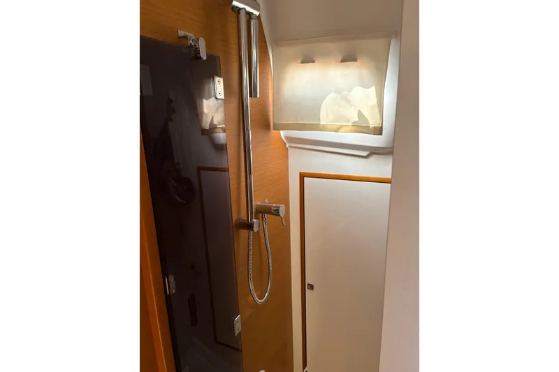Slide: The Image of Interior of 2017 Jeanneau Sun Odyssey 349 yacht bathroom with shower and wooden accents. - 32