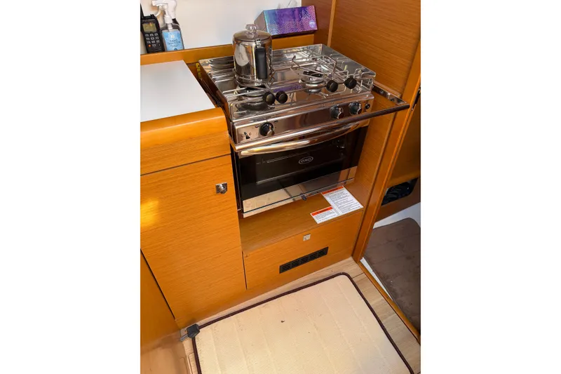 Slide: The Image of Compact kitchen area in a 2017 Jeanneau Sun Odyssey 349 sailboat with stove and oven. - 37