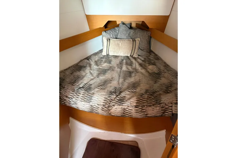 Slide: The Image of Cozy cabin interior of 2017 Jeanneau Sun Odyssey 349 sailboat with patterned bedding. - 40