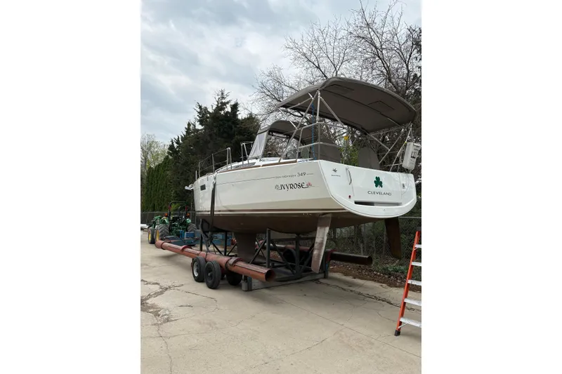 Slide: The Image of 2017 Jeanneau Sun Odyssey 349 sailboat on trailer, parked outdoors. - 6
