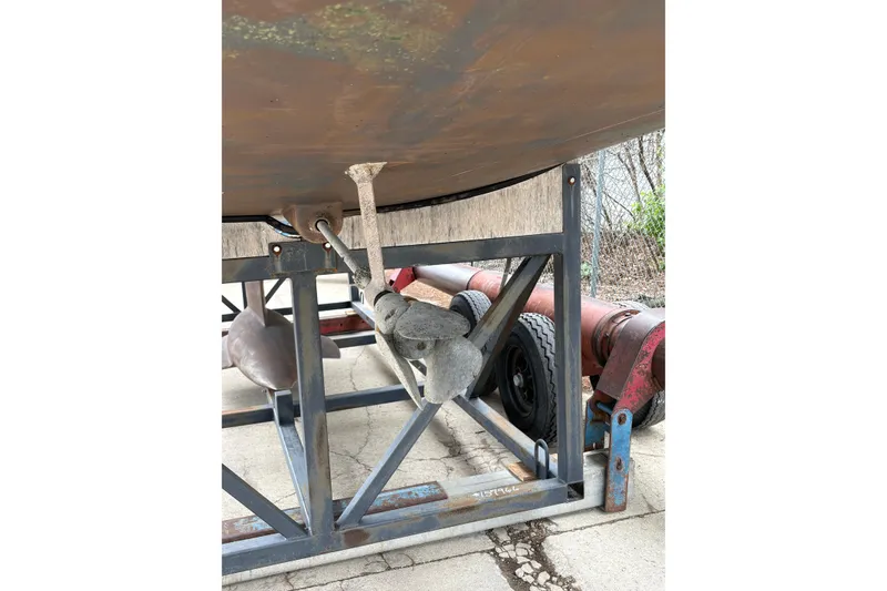 Slide: The Image of 2017 Jeanneau Sun Odyssey 349 sailboat hull and propeller on a metal stand. - 9