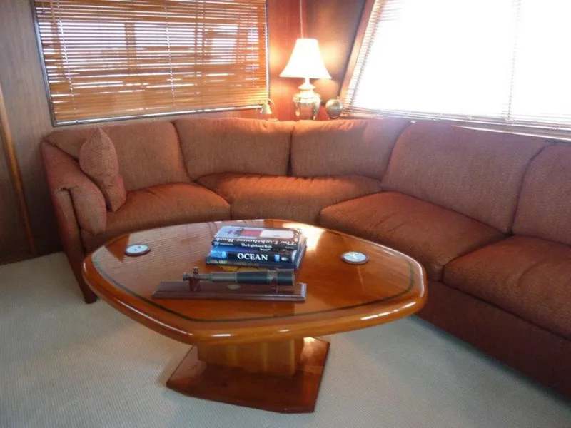 Slide: The Image of Luxurious 1987 Hatteras Flybridge interior with cozy seating and elegant wooden table. - 4