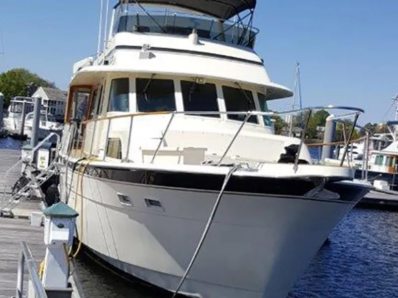 Slide: The Image of 1987 Hatteras Flybridge yacht docked at marina on a sunny day. - 46