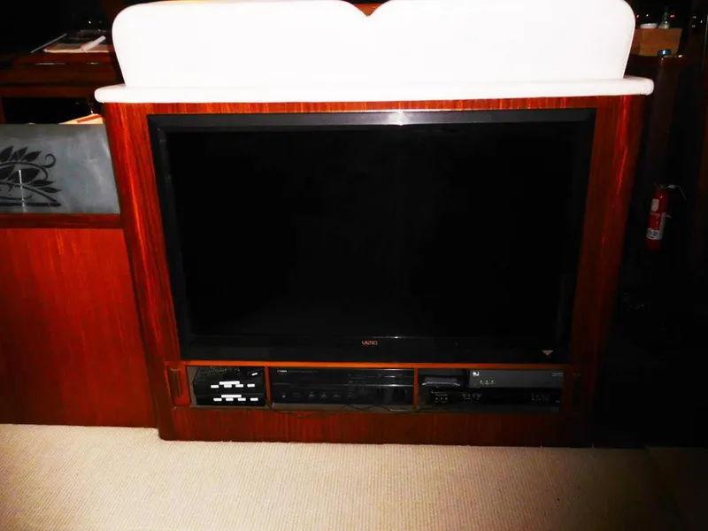 Slide: The Image of 1987 Hatteras Flybridge interior with built-in Vizio TV and entertainment system. - 8
