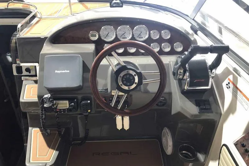 Slide: The Image of 2007 Regal 3350 Sport Cruiser dashboard with steering wheel and navigation controls. - 13