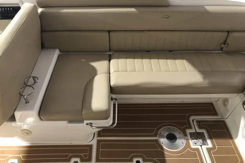 Slide: The Image of 2007 Regal 3350 Sport Cruiser interior with beige seating and wood-patterned flooring. - 17