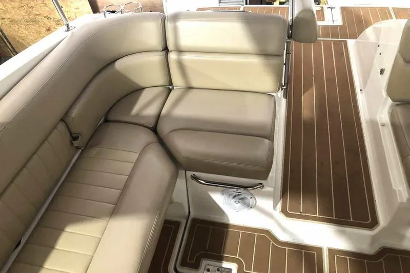 Slide: The Image of 2007 Regal 3350 Sport Cruiser interior with beige seating and wood-patterned flooring. - 18