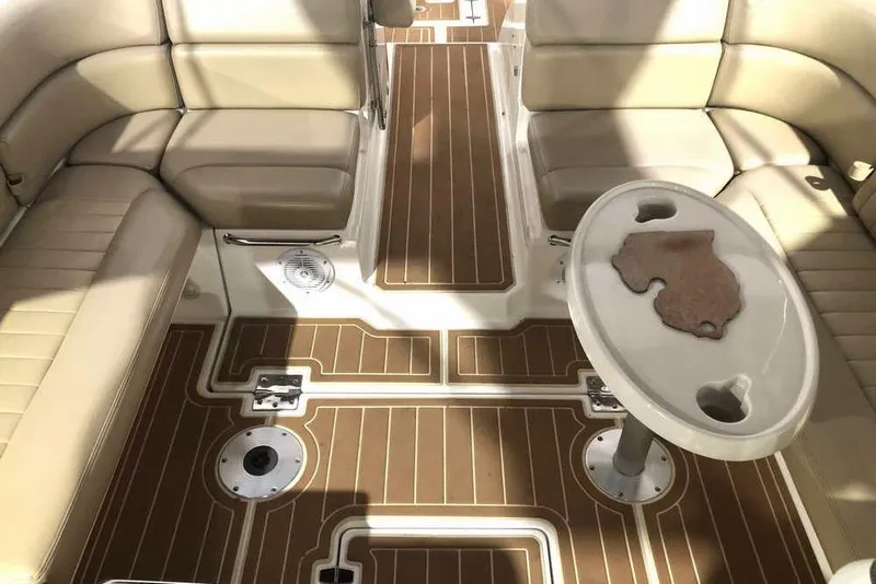 Slide: The Image of 2007 Regal 3350 Sport Cruiser interior with beige seating and wood-patterned flooring. - 19