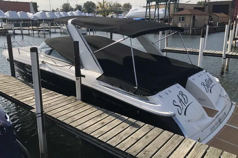 Slide: The Image of 2007 Regal 3350 Sport Cruiser docked at a marina with black canopy. - 2