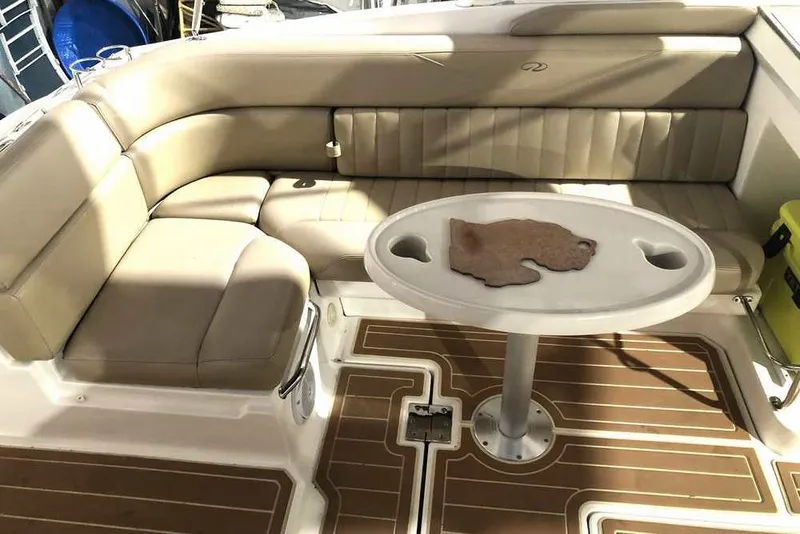 Slide: The Image of 2007 Regal 3350 Sport Cruiser interior with beige seating and round table. - 20