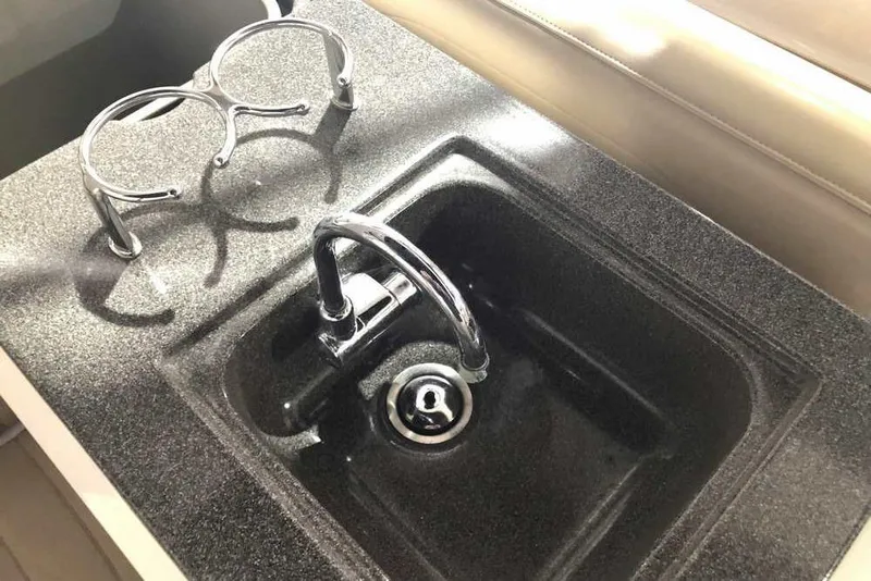 Slide: The Image of 2007 Regal 3350 Sport Cruiser sink with chrome faucet and cup holders. - 23