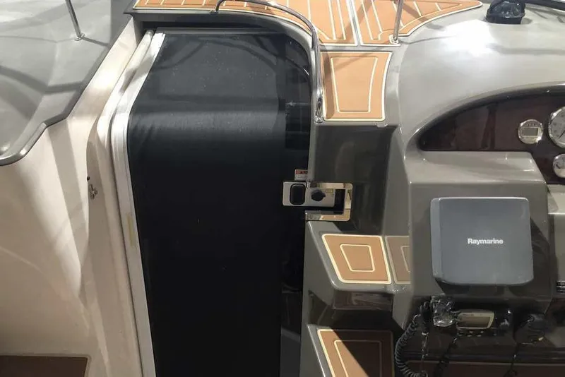 Slide: The Image of 2007 Regal 3350 Sport Cruiser cockpit with Raymarine equipment and sleek design details. - 27