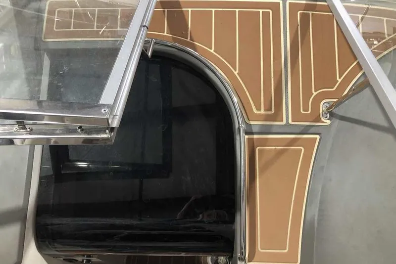 Slide: The Image of 2007 Regal 3350 Sport Cruiser deck with open hatch and brown flooring. - 28