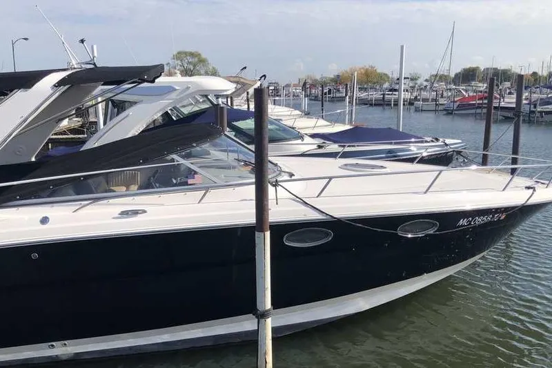 Slide: The Image of Freshwater 2007 Regal 3350 Sport Cruiser docked at a marina, featuring sleek black and white design. - 4