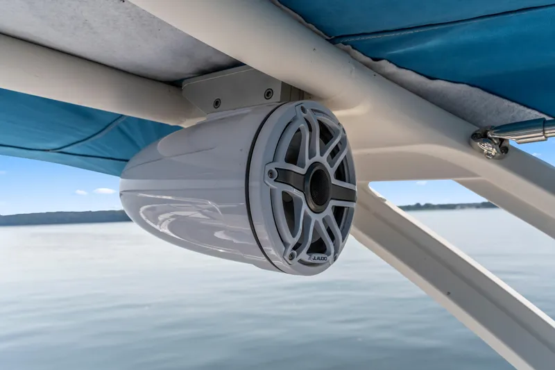 Slide: The Image of Speaker mounted on a 2022 Chaparral 247 SSX boat, under blue canopy. - 19