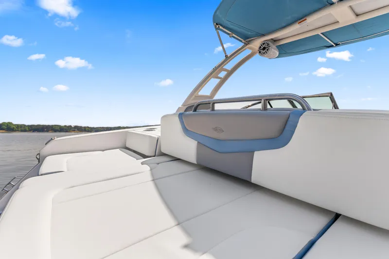 Slide: The Image of 2022 Chaparral 247 SSX boat interior with cushioned seating and blue canopy. - 21