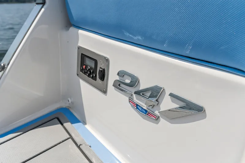 Slide: The Image of 2022 Chaparral 247 SSX boat interior with control panel and logo detail. - 24