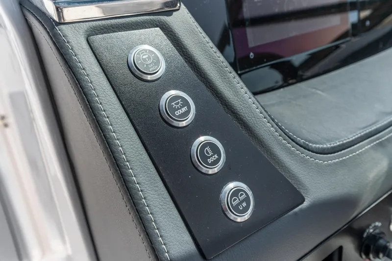 Slide: The Image of 2022 Chaparral 247 SSX dashboard with control buttons for various boat functions. - 7