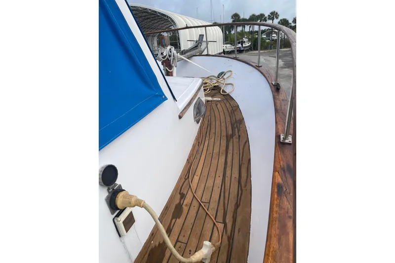 Slide: The Image of 1981 Albin 36 Trawler deck with wooden flooring and blue canopy. - 12