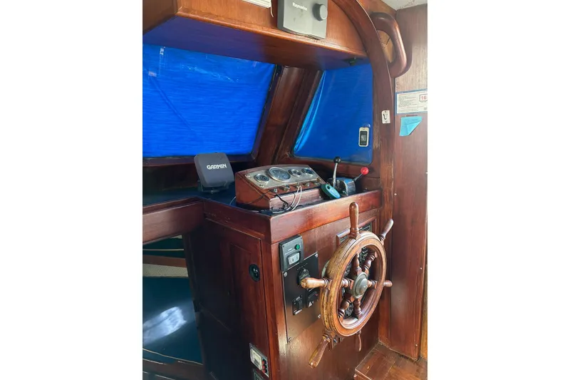 Slide: The Image of 1981 Albin 36 Trawler helm with wooden wheel and navigation instruments. - 20