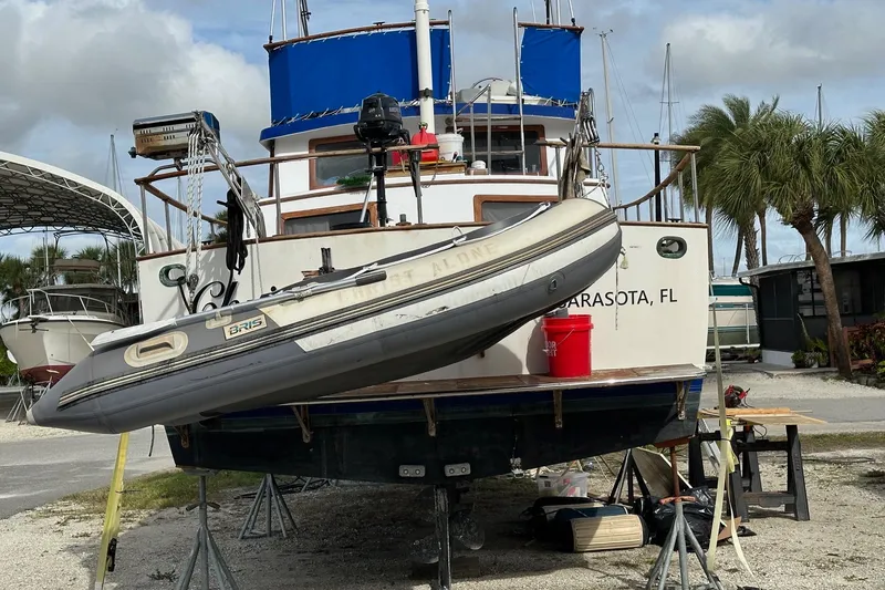 Slide: The Image of 1981 Albin 36 Trawler on stands with inflatable boat, Sarasota, FL backdrop. - 23