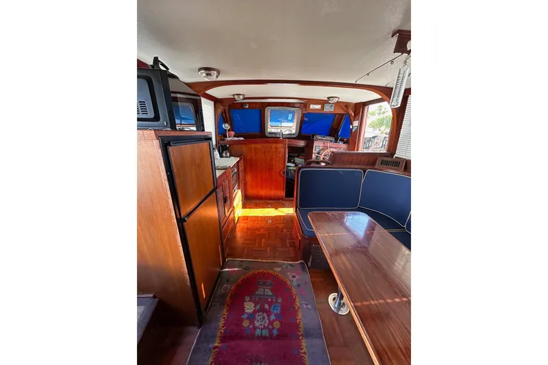 Slide: The Image of Interior of 1981 Albin 36 Trawler with wood finishes and blue seating. - 27