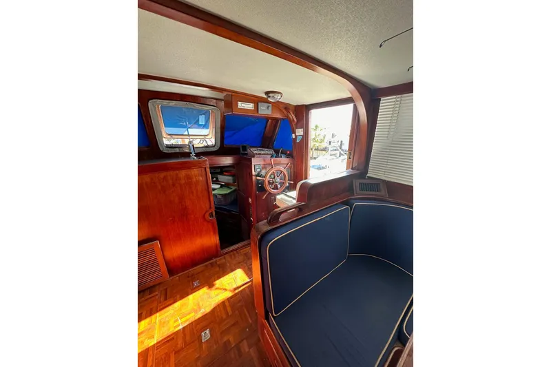 Slide: The Image of Interior of 1981 Albin 36 Trawler with wooden helm and blue seating. - 28