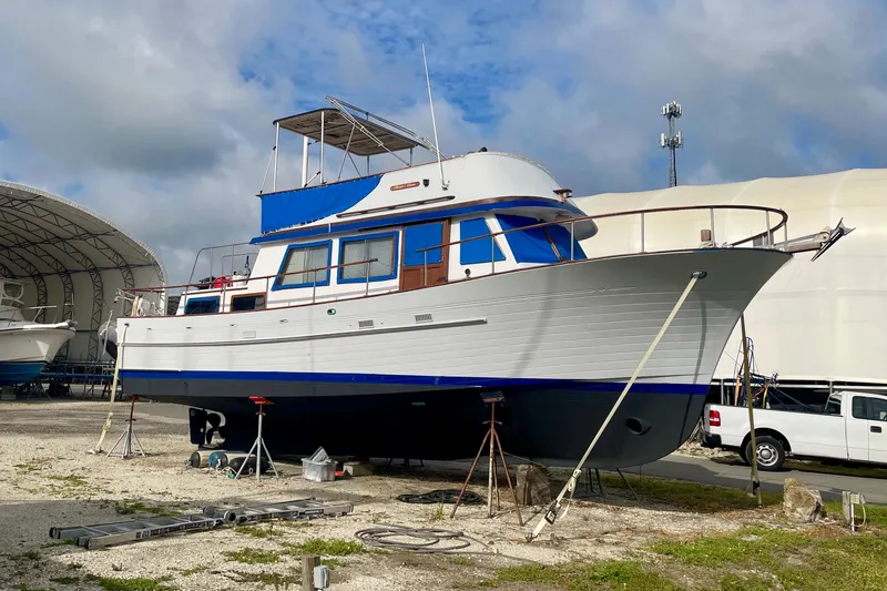 Slide: The Image of 1981 Albin 36 Trawler on dry dock, showcasing classic design and sturdy build. - 3