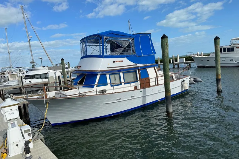 Slide: The Image of 1981 Albin 36 Trawler docked at marina under blue sky. - 43