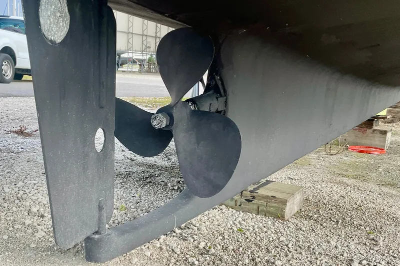 Slide: The Image of Propeller and rudder of 1981 Albin 36 Trawler on gravel surface. - 9