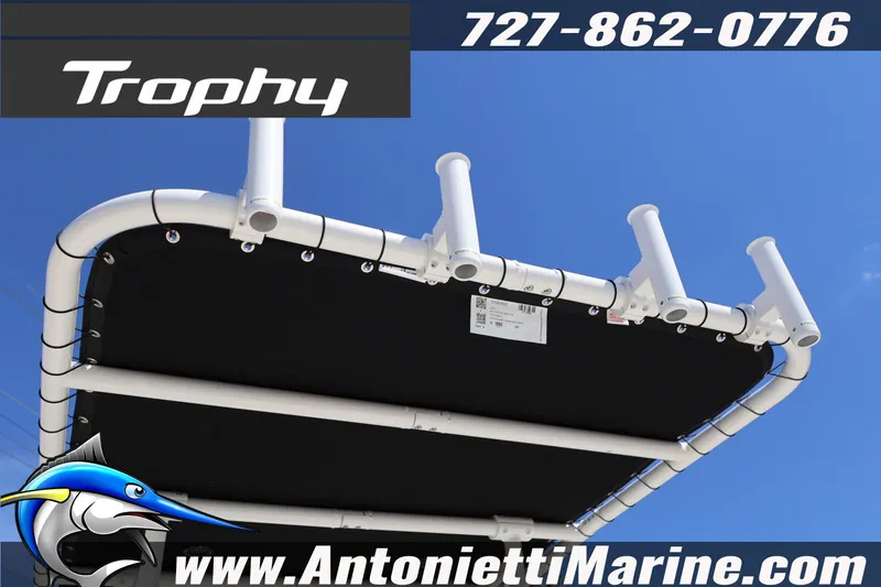 Slide: The Image of 2026 Bayliner Trophy T18 boat canopy with rod holders, blue sky background. - 20