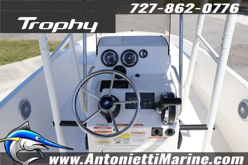 Slide: The Image of 2026 Bayliner Trophy T18 boat dashboard with steering wheel and controls. - 21